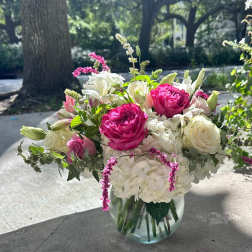 Pink and white floral arrangement in a clear glass vase
