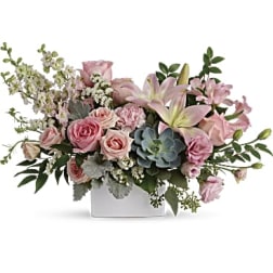 Low pink rose and lily arrangement with a succulent in a white rectangular vase