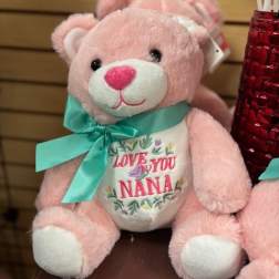 Pink teddy bear with a teal ribbon and "Love You Nana" on its belly