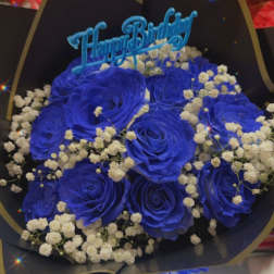 Blue rose bouquet with baby's breath and a Happy Birthday topper