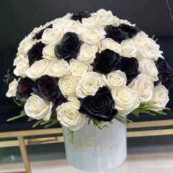 Black and white rose arrangement in a white hat box