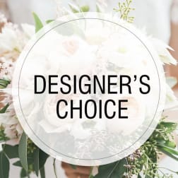White floral arrangement with mixed blooms and greenery, overlaid with "DESIGNER'S CHOICE" text