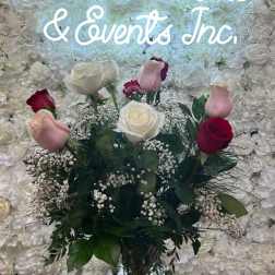 Bouquet of pink, white, and red roses in a glass vase