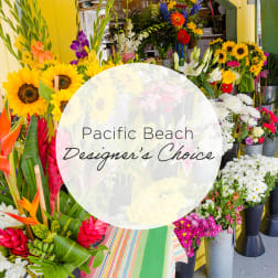 Assorted tropical and mixed flower bouquets in buckets with a "Pacific Beach Designer's Choice" sign