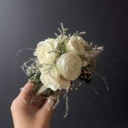 Small bouquet of white roses with delicate filler and grasses