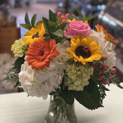 Colorful bouquet of mixed flowers in a clear glass vase