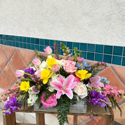 Mixed bouquet with pink tulips, roses, lilies, and yellow daffodils