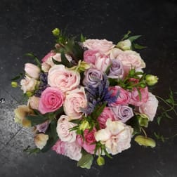 Bouquet of pink and lavender roses with purple accents