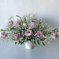 Pink and white floral arrangement in a white vase