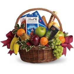 Gift basket with fruit, chocolate bars, and a ribbon