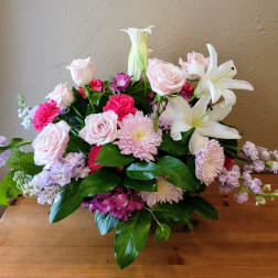 Bouquet of pink roses, lilies, and chrysanthemums with lavender accents