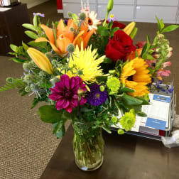 Colorful mixed bouquet in a clear glass vase