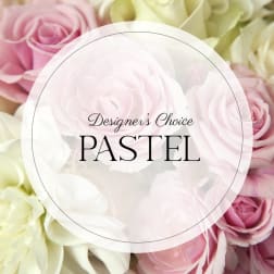 Pastel roses in pink, cream, and white fill the frame.