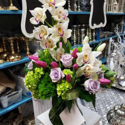 White orchids and lavender roses in a vase with pink tulips