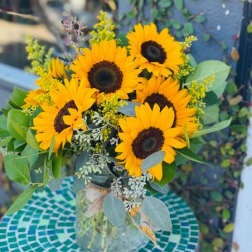 Bouquet of yellow sunflowers in a glass vase