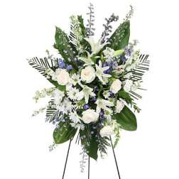 White and blue floral standing spray on an easel
