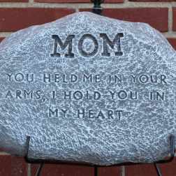 Memorial stone engraved with "MOM" and a tribute message