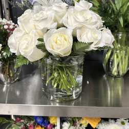 White roses arranged in a clear glass vase
