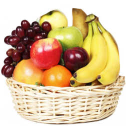 Basket of assorted fruit including bananas, apples, grapes, and oranges