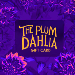 Purple gift card with yellow text reading The Plum Dahlia