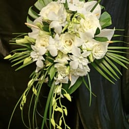 White floral bouquet with roses and orchids on a dark background