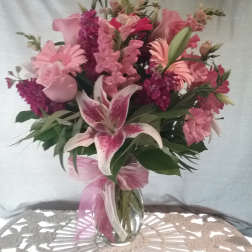 Pink mixed bouquet with lilies and roses in a glass vase