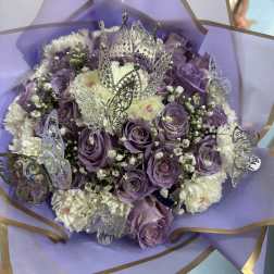 Purple and white bouquet with butterfly decorations and a crown topper