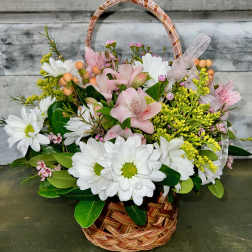 Basket arrangement of white daisies and pink lilies with a ribbon bow
