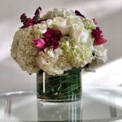 White and pink floral arrangement in a clear glass vase