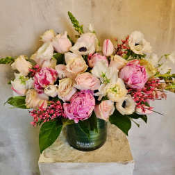 Pink and white flower arrangement in a green vase