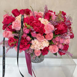 Large bouquet of pink and red roses in a clear vase