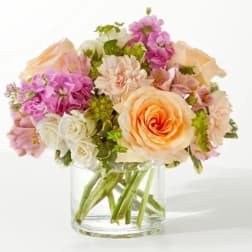 Pink and peach mixed bouquet in a clear glass vase