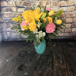 Yellow and pink mixed bouquet in a turquoise vase