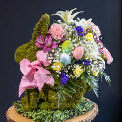 Moss-covered bunny-shaped floral arrangement with pink ribbon and pastel flowers