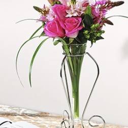 Pink roses and lilies arranged in a tall glass vase