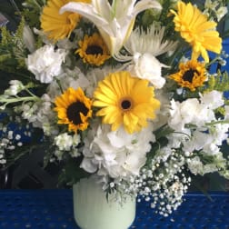 White lilies and yellow gerbera daisies in a vase