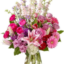 Mixed pink and purple bouquet in a clear glass vase