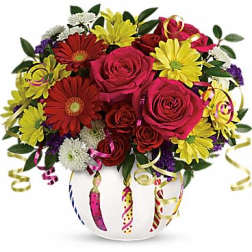 Bouquet of red roses and yellow daisies in a white vase with curling ribbons