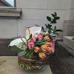 Tulip and anthurium arrangement in a glass bowl vase