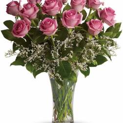 Pink roses arranged in a clear glass vase