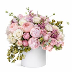 Pink and white rose bouquet in a white cylindrical vase