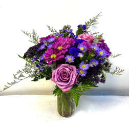Purple and pink mixed bouquet in a glass vase