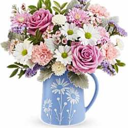 Pink and white mixed bouquet in a blue floral pitcher
