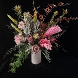 Pink and white floral arrangement in a white vase
