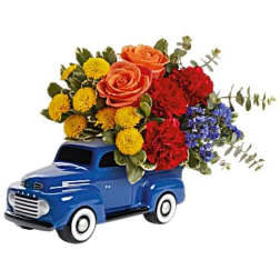 Blue toy truck holding a colorful flower arrangement