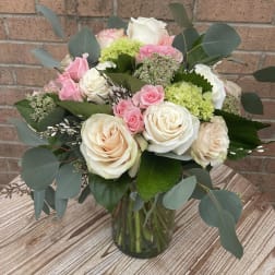 Bouquet of pink and white roses in a glass vase