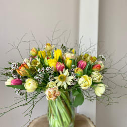 Mixed tulip bouquet in a clear glass vase