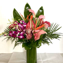 Tropical bouquet with pink orchids and anthurium in a green glass vase