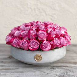 Round box filled with pink roses