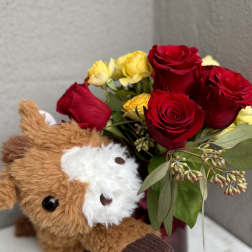 Red and yellow roses with a plush teddy bear